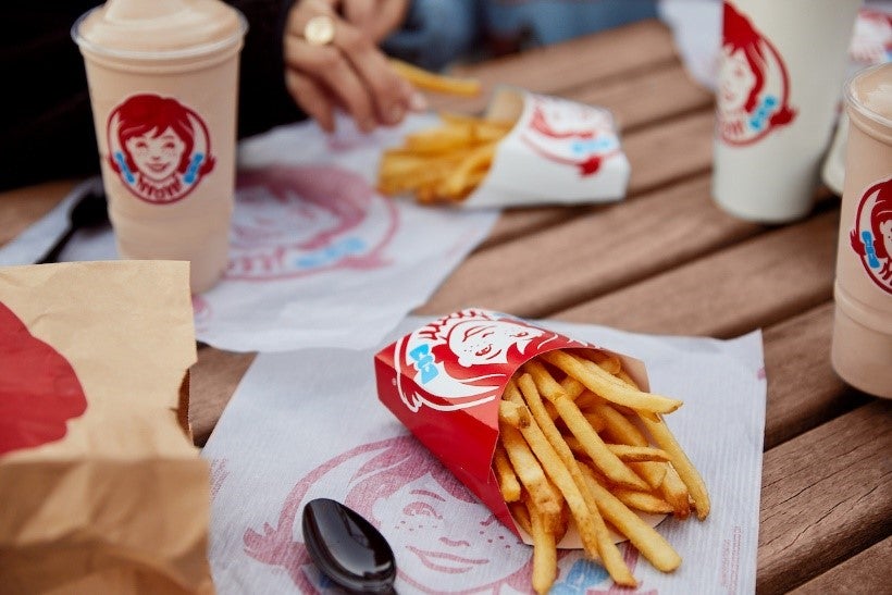 French fries in a red container on a table</p>
<p>AI-generated content may be incorrect., Picture